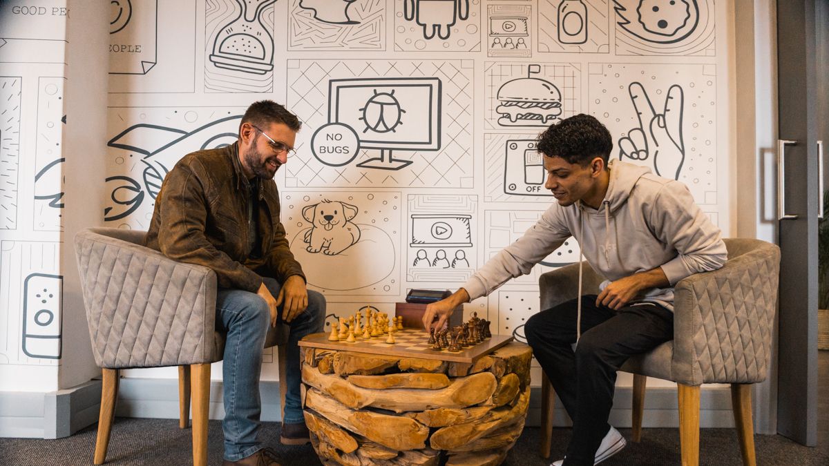 Two team members playing chess in the office lounge