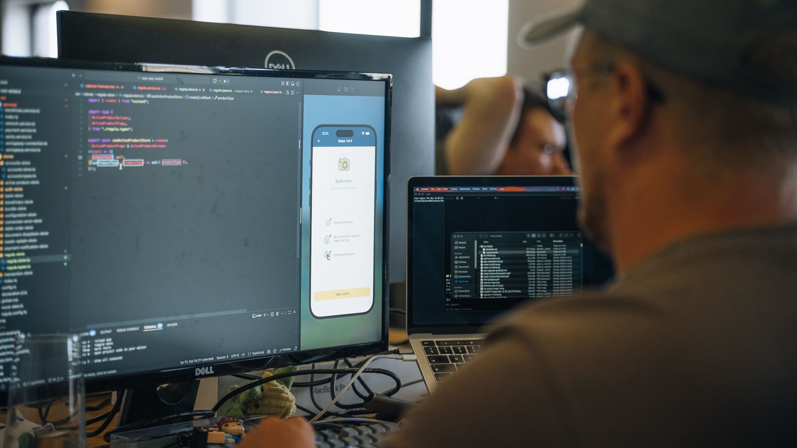 A Codehesion developer building a mobile app, code on one side and the running app on the other